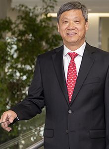 Seto, Edward standing next to a railing